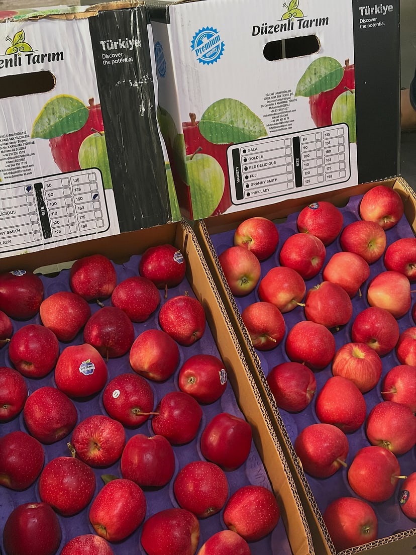 Close view of two opened apple cartons with their printed carton labels