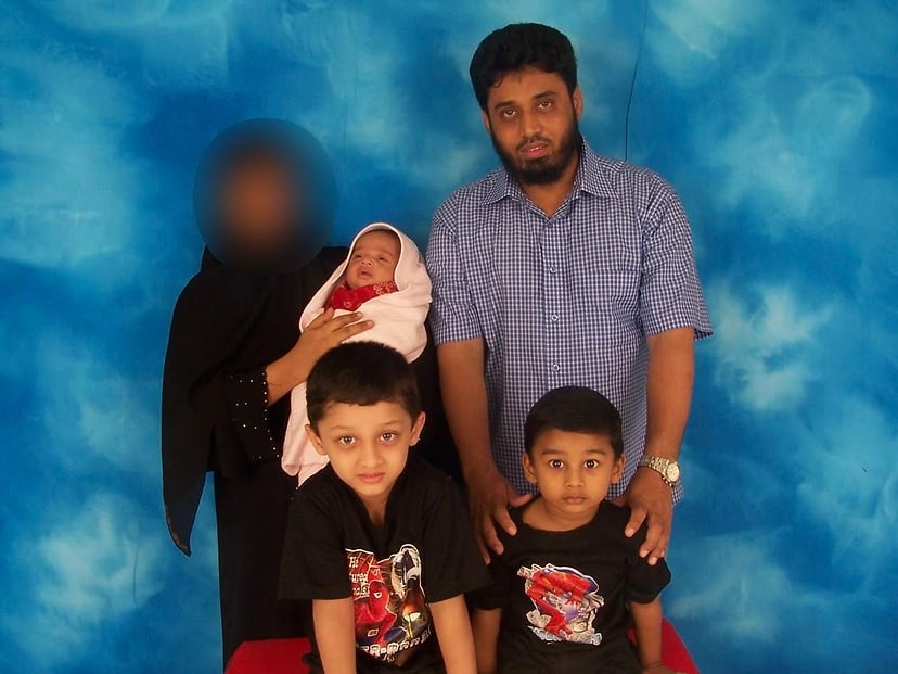 A photograph from the Sultan family album against a blue studio backdrop